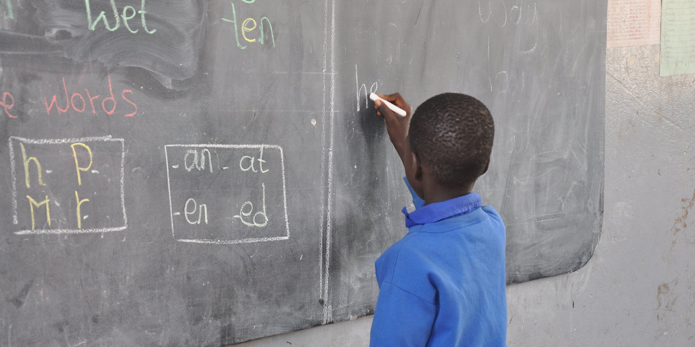 A child writes on the blackboard. The Gambia. Credit: GPE/Jim Cham